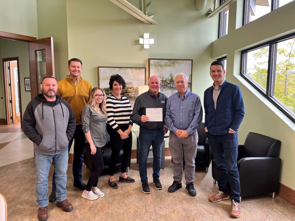 E-Tank team presenting a donation check to The Legacy Project, supporting local youth mentoring programs through proceeds from the E-Tank Classic charity golf outing.