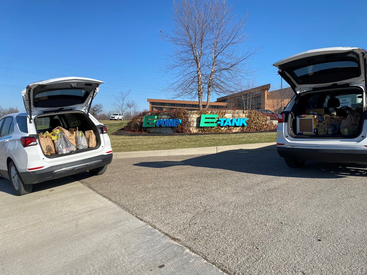 E-Tank vehicles filled with food donations for Thanksgiving community drive outside E-Tank and E-Pump headquarters