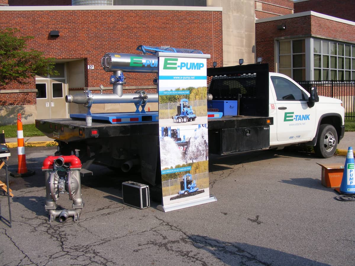 E-Pump equipment displayed on E-Tank flatbed truck during community outreach event, showcasing pump technology and rental services