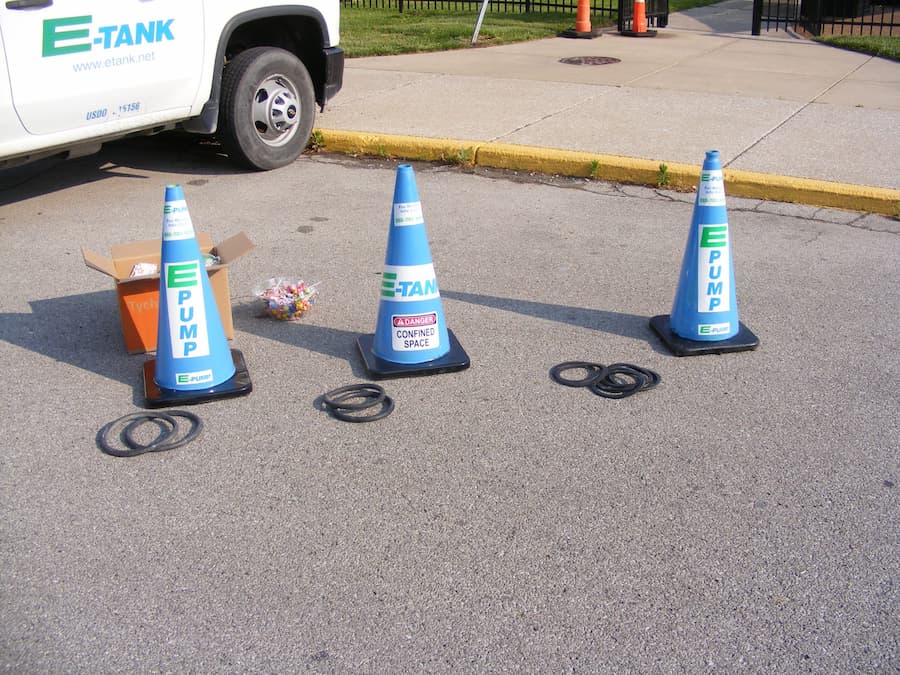 E-Pump branded safety cones and display items set up near E-Tank truck during community safety and equipment demonstration event