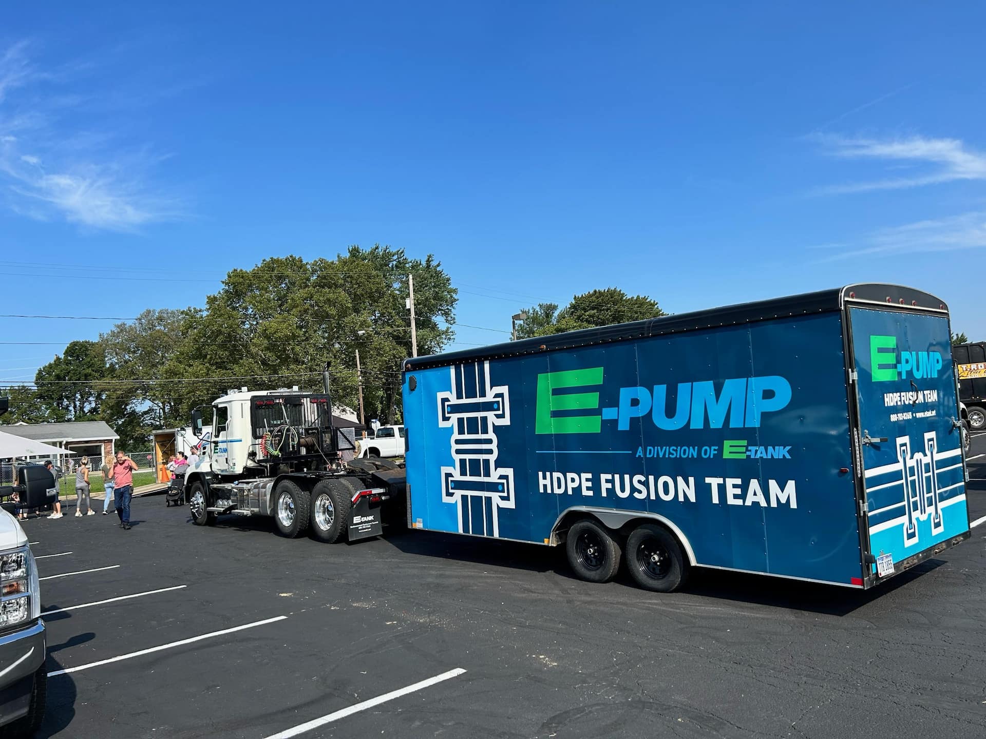 E-Tank truck towing E-Pump HDPE Fusion Team trailer at community Touch-A-Truck event, demonstrating equipment and services