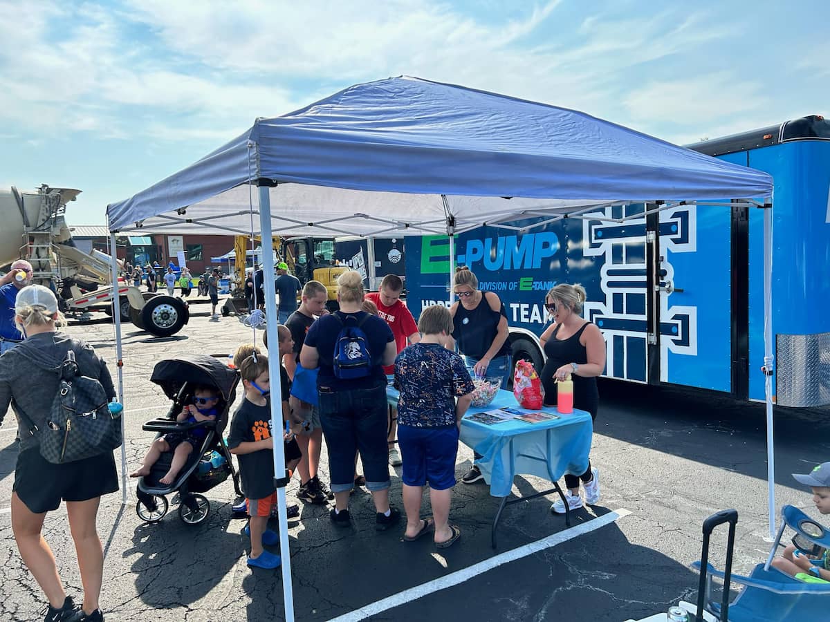 Families visiting E-Pump HDPE Fusion Team booth at Touch-A-Truck community event, engaging children with hands-on learning activities