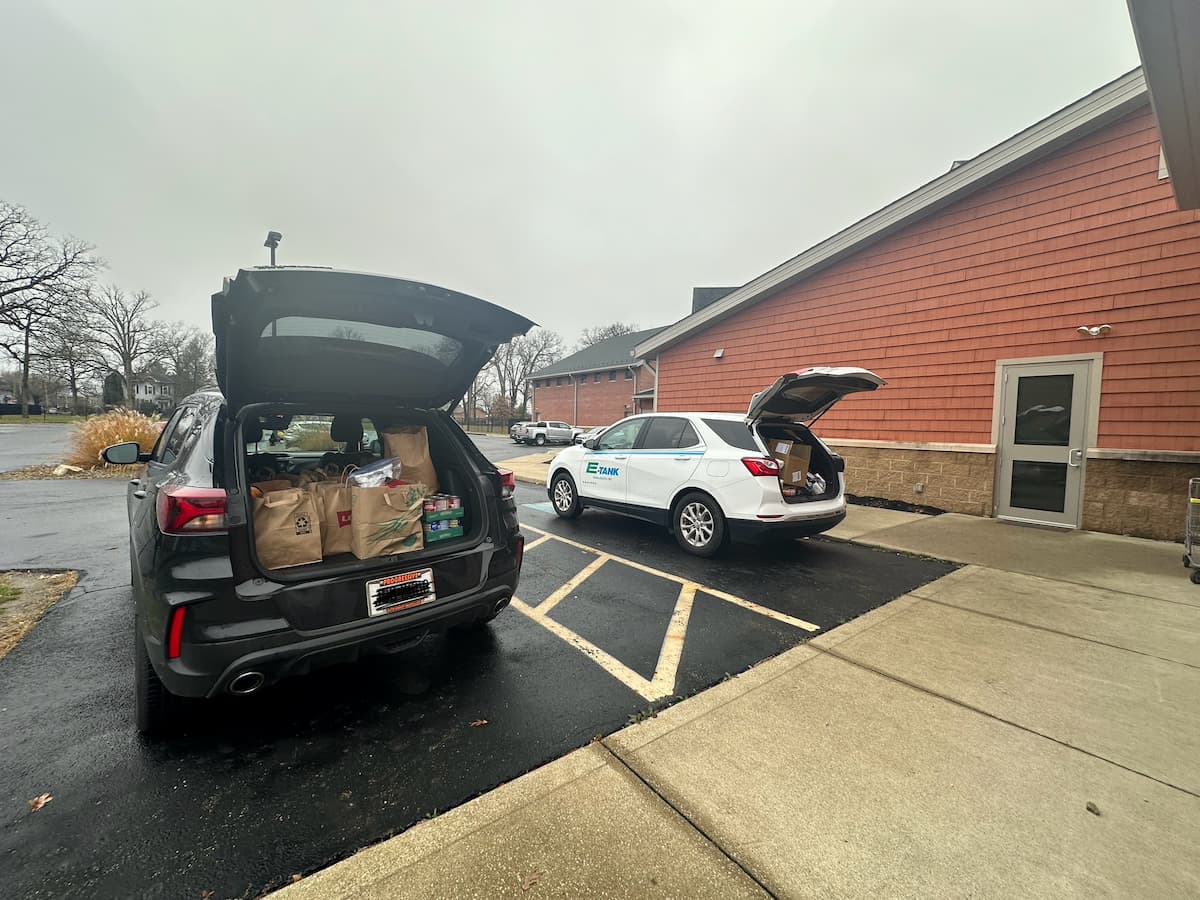 E-Tank vehicle delivering food donations for Thanksgiving food drive, supporting local community assistance initiatives