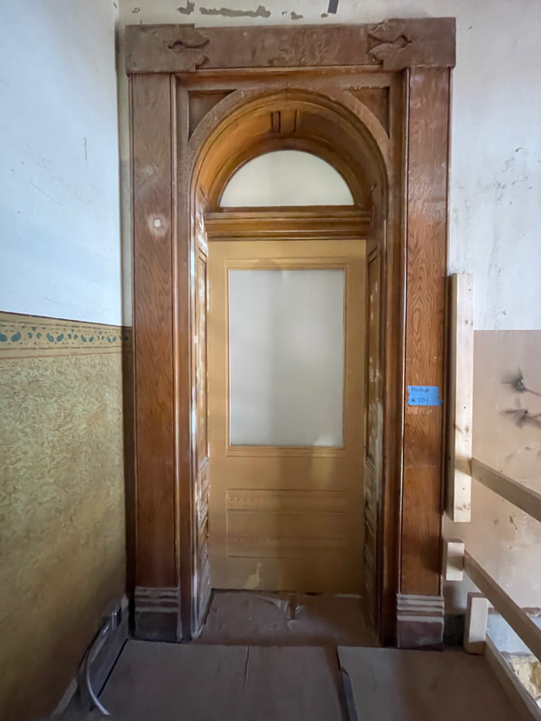 Restored arched wood door at Perry County Courthouse with Ribbon Sapele frame and precision-fit millwork by Rockwood Door.