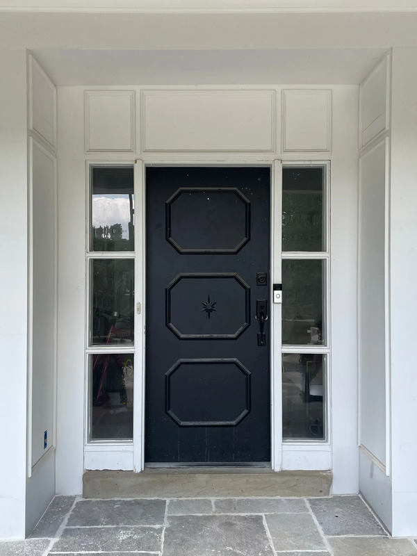 Original front entry with black paneled door and sidelights before restoration, showing historic proportions and moulding details to be replicated by Rockwood.