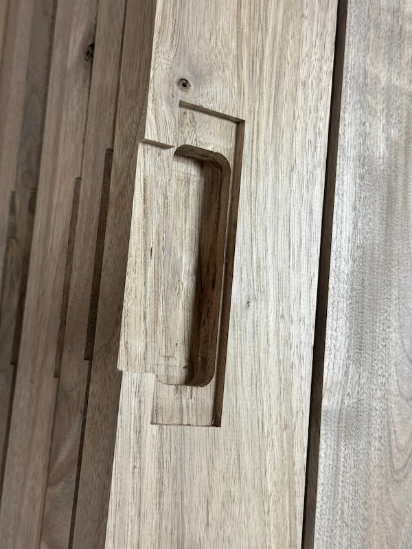 Close-up of handle recess milled into solid walnut door slab, showcasing Rockwood’s precision craftsmanship and attention to detail.