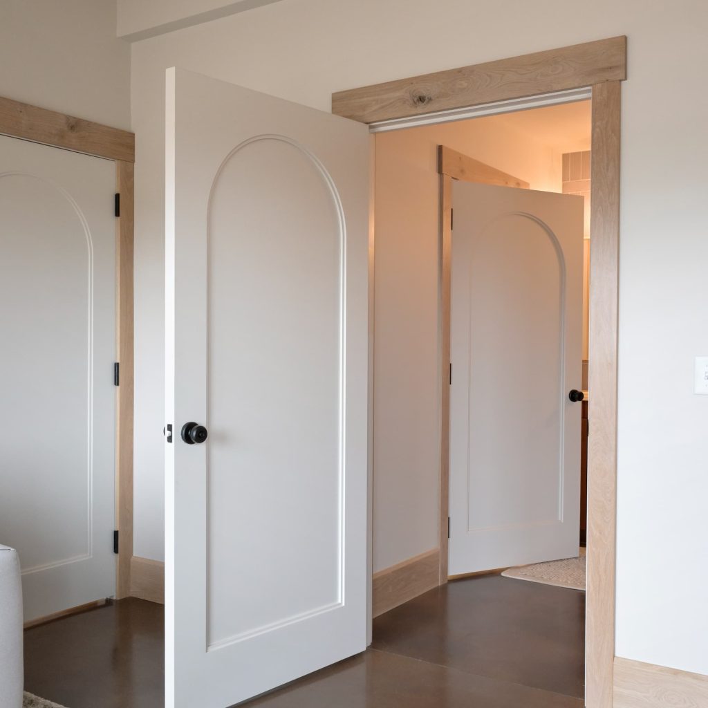 Bedroom with interior painted wood door open